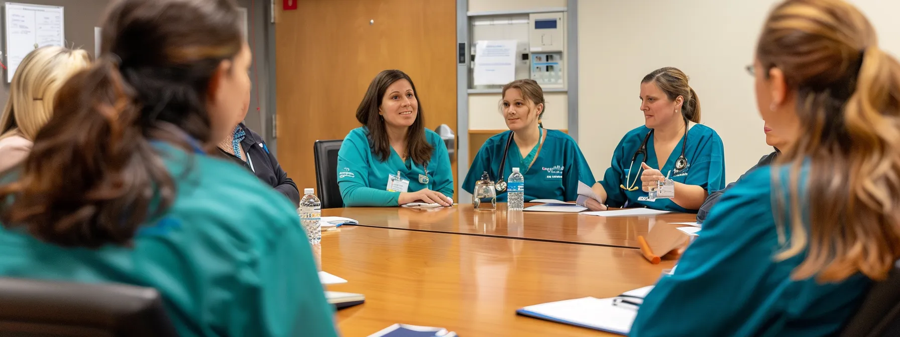 a group of healthcare professionals in scrubs gathered around a conference table, studying documents and discussing the implications of policy changes on medicare careers.